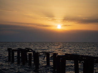 Fototapeta na wymiar Epic sunset (dawn) on the sea. Waves are breaking on stones.