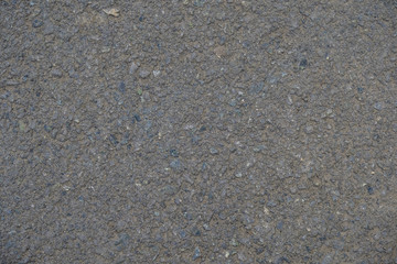 The road is made of asphalt. Background of stone.