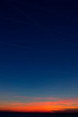 Apstract red blurry clouds on a dark blue sky during sunset