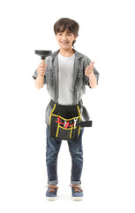 Portrait of little plumber showing thumb-up gesture on white background