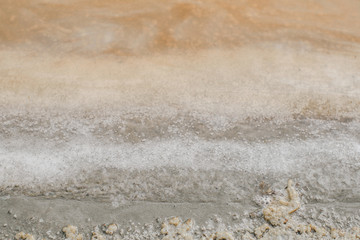 Salty sea shore.Texture of sea salt farm is the place with so much sea-salt production in the country,or salt evaporation plant these ponds have vivid colors.Thailand,Samut Songkhram,Samut Sakhorn