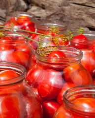 Pickling (canning) the tomatoes.
