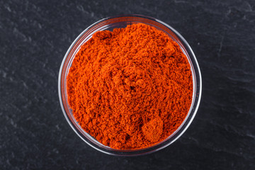 aromatic ground paprika on a dark stone background