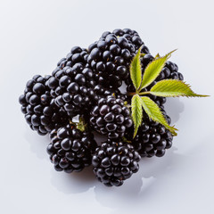 juicy blackberries on a white acrylic background