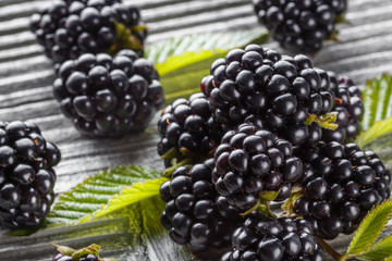 juicy blackberries on gray wooden rustic background