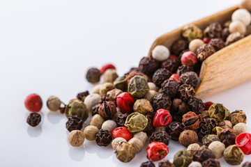 mix of peppercorns on white acrylic background