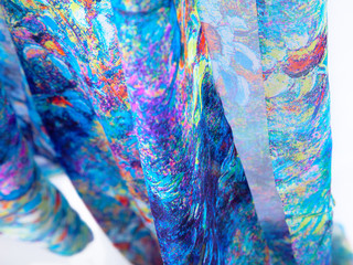 Fabric natural silkworm silk, Chinese silk, bright blue-blue colors. Print wild flowers. Translucent. Texture, background, Wallpaper, close-up. The fabric hangs down on a white background.
