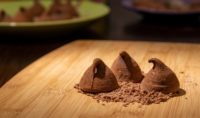 Chocolate truffles with grated chocolate on the table.