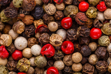 mix of peppercorns on white acrylic background