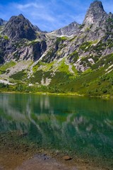 Naklejka na ściany i meble Green lake surrounded by Tatra peaks.