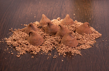 Chocolate truffles with grated chocolate on the table.