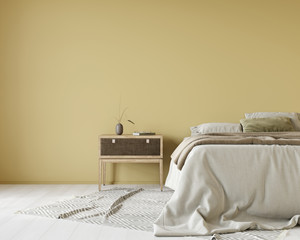 Yellow bedroom with a bed covered with linen bedcover and a wooden bedside table - obrazy, fototapety, plakaty