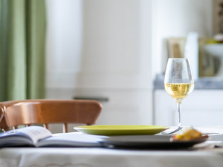 a glass of white wine. Breakfast with toast. work at home