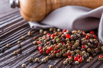 mix of peppercorns on a dark wooden rustic background