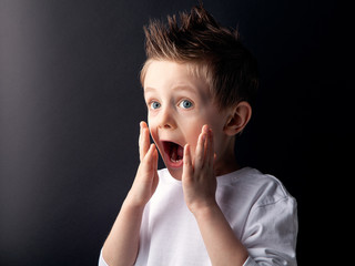 A beautiful blue-eyed white boy screams, is surprised, is amazed. Expresses bright joy. Shock, wow....