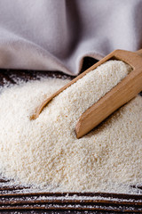 natural organic semolina on dark wooden rustic background
