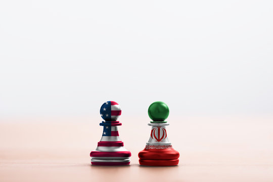 USA Flag And Iran Flag Print Screen On Pawn Chess With Soft Light Background.It Is Symbol Of United State Of America And Iran Have Conflict In Nuclear Weapons And Strait Of Hormuz.