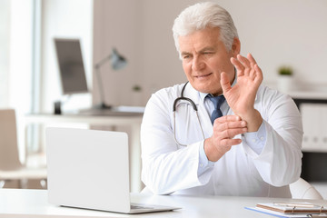Male doctor giving a consultation online in clinic