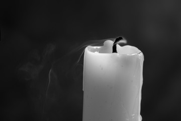 Smoke from an extinguished candle isolated on a black background. Can be used as background. Symbol of sorrow