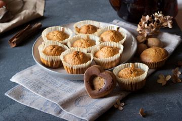 dark photo of carrot muffins and tea pot