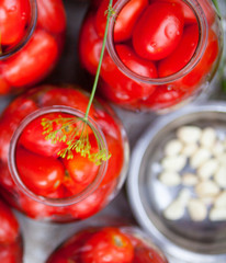 Pickling (canning) the tomatoes.