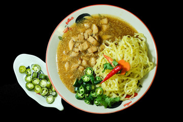  Chicken with sauce over Noodles in Thailand traditional street food with black color background 