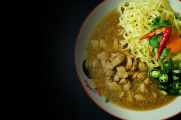  Chicken with sauce over Noodles in Thailand traditional street food with black color background 