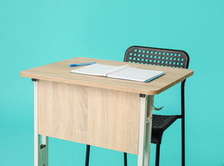 Modern school desk on color background
