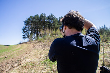 Young man takes pictures on camera. Minsk, Belarus - May 02 2020