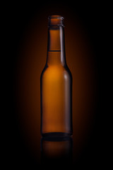 Brown small bottle full of liquid on a black background