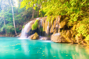 Fototapeta na wymiar Waterfall landscape with beautiful emerald lake and green tree in wild jungle forest. Erawan National park, Thailand