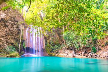 Waterfall landscape with beautiful emerald lake and green tree in wild jungle forest. Erawan National park, Thailand