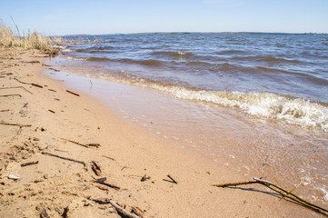Fototapeta na wymiar Golden sandy seashore with transparent wave