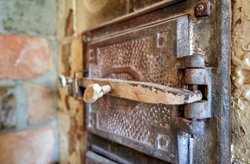 Metal door with a tick for the old tiled stove