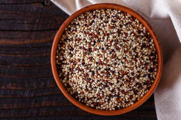 mix of quinoa grains on dark wooden rustic background