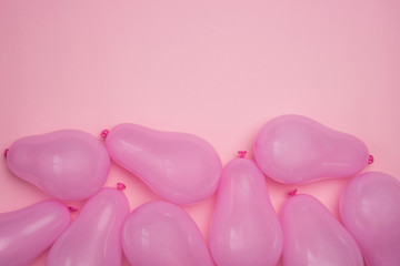 Many pink balloons on pink background. Monochrome balloon background with free space for text. Festive decor. Top view flat lay. 