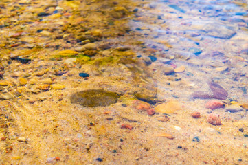 Golden mountain stream with beautiful stones and clear water