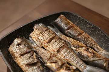 Grilled spicy fish on desk. Roasty fish concept.