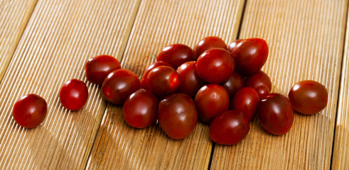 Naklejka na ściany i meble Cherry tomatoes on wooden table