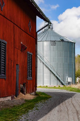 Norrkoping, Sweden May 1, 2020 A corn silo on a farm and a red barn. © Alexander