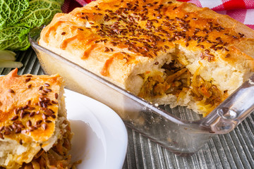 freshly baked cabbage pie on rustic wooden background