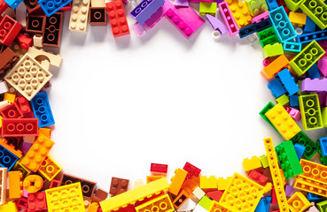 Colorful toy bricks frame with white empty space for your content © Tatsiana