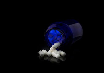 WHITE TABLETS ON A BLACK BACKGROUND