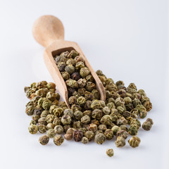 spicy green peppers on white acrylic background