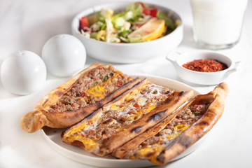 Traditional Turkish pide with meat and egg
