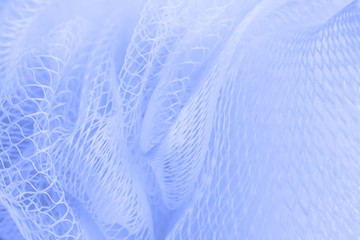 Naklejka na ściany i meble Blue abstract background. The texture of the polymer mesh closeup.