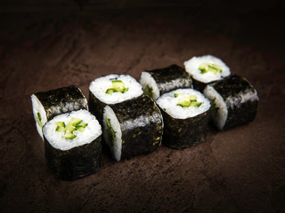 Japanese-style vegetarian rolls on a dark stone slab
