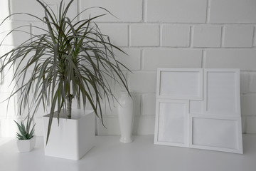 Interior. Decor for the home. Homemade flowers in white pots against a white brick wall.
