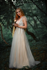Obraz na płótnie Canvas long haired blonde girl in white dress with lantern
