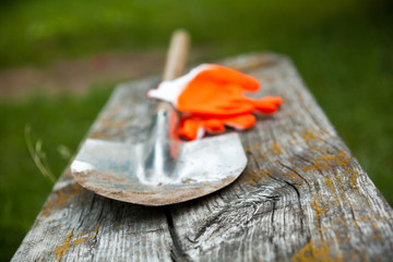 Metal spade and protective gloves